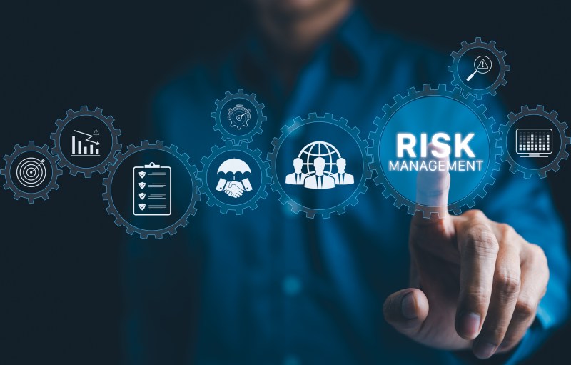 Risk analysis concept. Businessman interacts with digital interface displaying various icon related to risk management and assessment, including global connectivity, analytics, and strategic planning.
